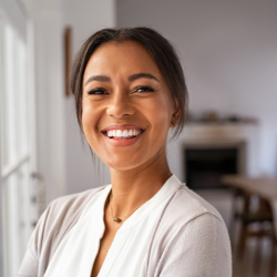 Woman near a window smiling at the camera