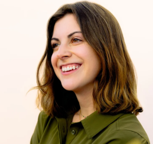 Brunette woman with green shirt smiling